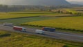 DRONE: Flying along two freight trucks hauling containers down country highway