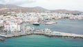 Drone is flying backwards with view of port of Tinos, Greek Island