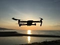 Drone flying in the beach at sunrise in summer