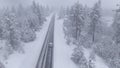 DRONE Flying behind a car driving through a snowstorm as commuter drives to work Royalty Free Stock Photo