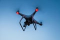 Drone is flying in the blue sky at sunset time. Royalty Free Stock Photo