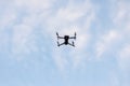 Drone flying on blue sky with white clouds background. Bottom view Quadcopter with digital camera. Flying remote control Royalty Free Stock Photo