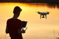 Drone flying. copter pilotage at river sunset Royalty Free Stock Photo