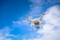 Drone flying in fromt of a blue sky Royalty Free Stock Photo
