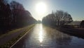 Drone flying low over river or canal and forest in Belgie