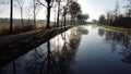 Drone flying low over river or canal and forest in Belgie