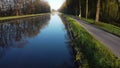 Drone flying low over river or canal and forest in Belgie