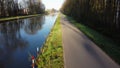 Drone flying low over river or canal and forest in Belgie