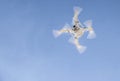 Drone flying over with camera against blue sky Royalty Free Stock Photo