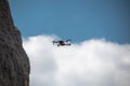 Drone flying over a cliff in the background of blue sky. Royalty Free Stock Photo
