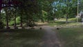 Drone flying over a green area in a park with lights and pic nic tables