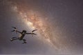 Drone flying in starry night sky showing the galaxy and stars