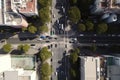 drone flyover of a busy city street, with the view from above showing cars and people in motion