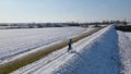 Drone footage of a biker pedaling on a field