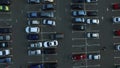 Drone footage cars parking at congested parking lots. people walking parking