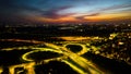 Drone footage huge multi lane circle roundabout intersection in city traffic highway night city. Public transport Royalty Free Stock Photo