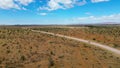 Drone footage of offroad vehicle driving on dirt road in African bush