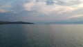 The drone gradually flies up over the surface of the water. Lake Baikal, nature of Russian Federation. Aerial Video Shot