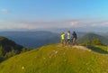 DRONE: Group of friends high fives after successful bike ride in green mountains