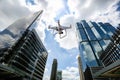 Drone with high resolution digital camera flying over city . An aerial view of a flying multi-copter with raised landing gears and Royalty Free Stock Photo