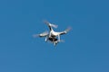 Drone hovering on the blue sky.