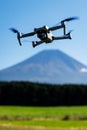 Drone hovering in front of Mount Fuji under clear sky Royalty Free Stock Photo