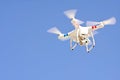 Drone Hovers Isolated Against Blue Sky