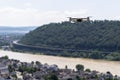 The drone hovers over the grape hills and countryside, the plastic propellers are on and the camera on the gimbal is visible.