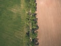drone image. aerial view of rural area with fields and forests and water reflections in river in cloudy spring day. latvia - Royalty Free Stock Photo