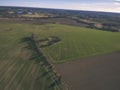 drone image. aerial view of rural area with fields and forests and water reflections in river in cloudy spring day. latvia - Royalty Free Stock Photo