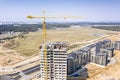 Drone image of city construction site with yellow industrial tower crane Royalty Free Stock Photo