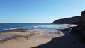 Drone image of a lone person walking along the shore of an empty beach cove, Torquay, Great Ocean Road, Victoria, Australia Royalty Free Stock Photo