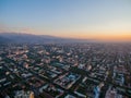 Drone Image Over City at Sunset With Mountains Royalty Free Stock Photo