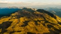 Drone landscape showing curved path across mountain ridge in evening light Royalty Free Stock Photo
