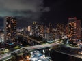 Drone long exposure view of Waikiki bridge with the city's modern architectures illuminated at night Royalty Free Stock Photo