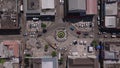 Drone look down shot of bustling roundabout in a Jamaica's square. Cars navigate streets of Montego Bay and