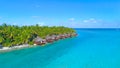 DRONE: Lush palm trees surround the oceanfront bungalows in sunny Cook Islands.