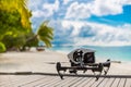 Drone making video footage and taking photographs on a tropical beach scene