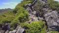 Drone Moves to Island Mountain and Girl Shows Likeness on Rocks