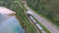 DRONE: Museum steam locomotive travels along a beautiful river and country road. Royalty Free Stock Photo