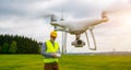 Drone operated by construction worker inspecting wind turbine Royalty Free Stock Photo