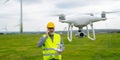 Drone operated by construction worker inspecting wind turbine Royalty Free Stock Photo