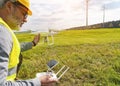 Drone operated by construction worker inspecting wind turbine Royalty Free Stock Photo