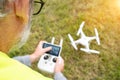 Drone operated by construction worker inspecting wind turbine