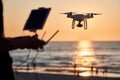 Drone operated by young man flying over an sea Royalty Free Stock Photo