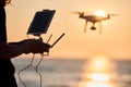 Drone operated by young man flying over an sea Royalty Free Stock Photo