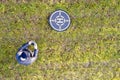 Drone operator aerial view with landing and take off target pad must register flying quadcopter Royalty Free Stock Photo