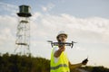 Drone operator piloting a drone