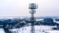 Drone orbiting around 5G antenna covered in snow.