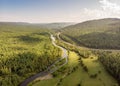 Drone over a river, country road and forest. Aerial amazing view of streams Royalty Free Stock Photo